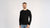Man sitting on the sofa and wearing Merino wool long sleeve top
