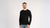Man wearing a black long-sleeve shirt on a white background