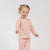 Side view of child in pink bamboo long-sleeve top and bottoms.
